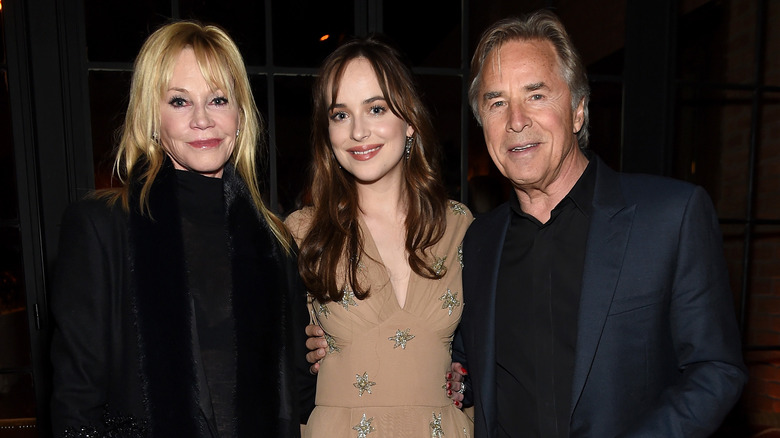 Dakota Johnson posing with Melanie Griffith and Don Johnson