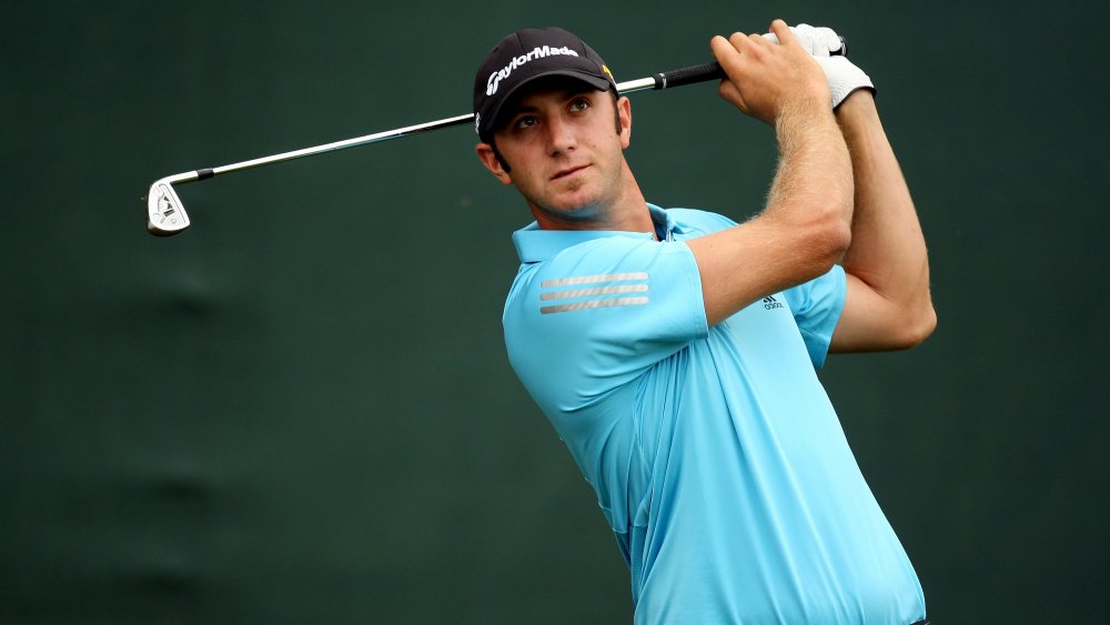 Dustin Johnson golfing in a light blue polo