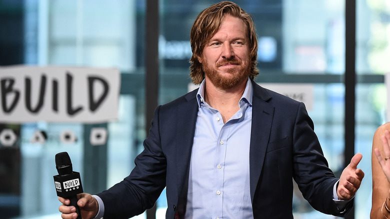 Chip Gaines with arms outstretched during Build series interview