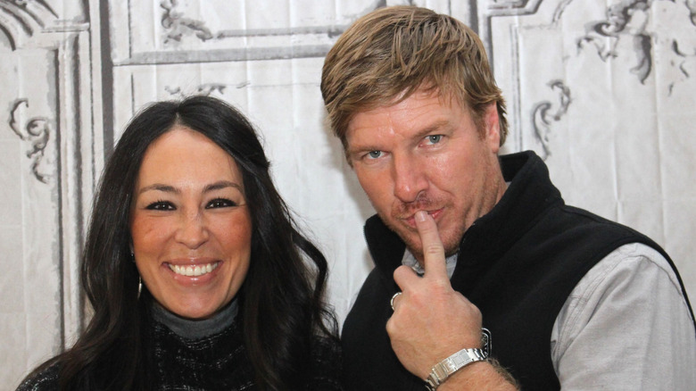 Joanna Gaines smiling, Chip Gaines putting finger on lips