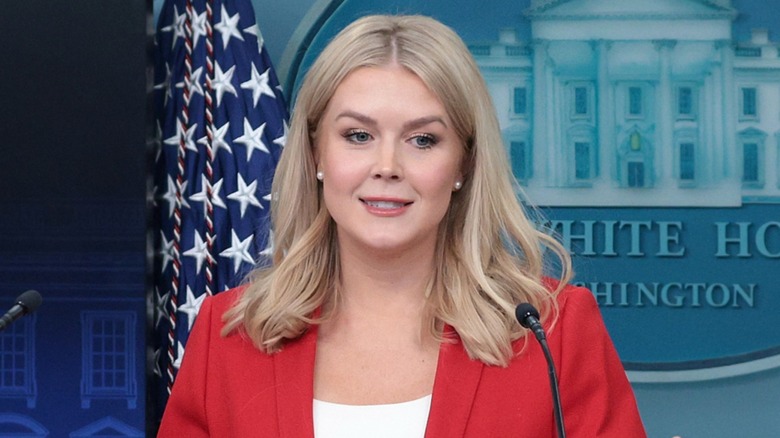 Karoline Leavitt smiles on the podium during a White House press briefing.