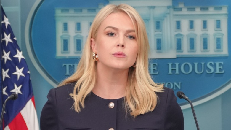Karoline Leavitt appears to be listening attentively during a session at the White House press briefing room.