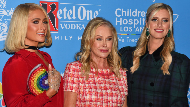 Paris, Kathy and Nicky Hilton at an event, all smiling