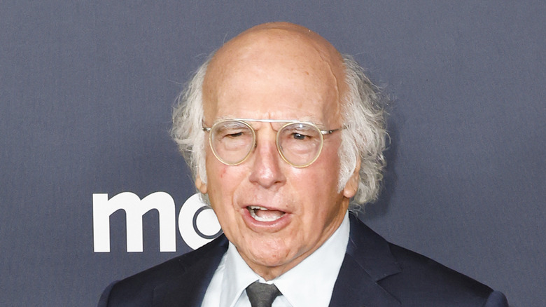 Larry David round glasses talking