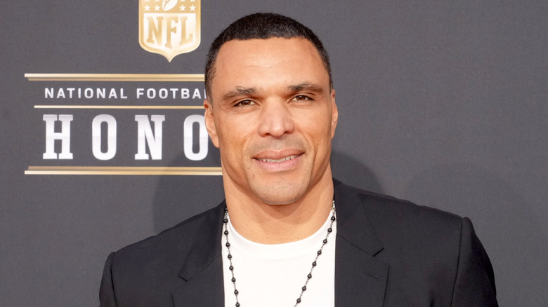 A split image of Lauren Sanchez smiling as she sports a bright orange dress, and Tony Gonzalez speaking into a microphone.