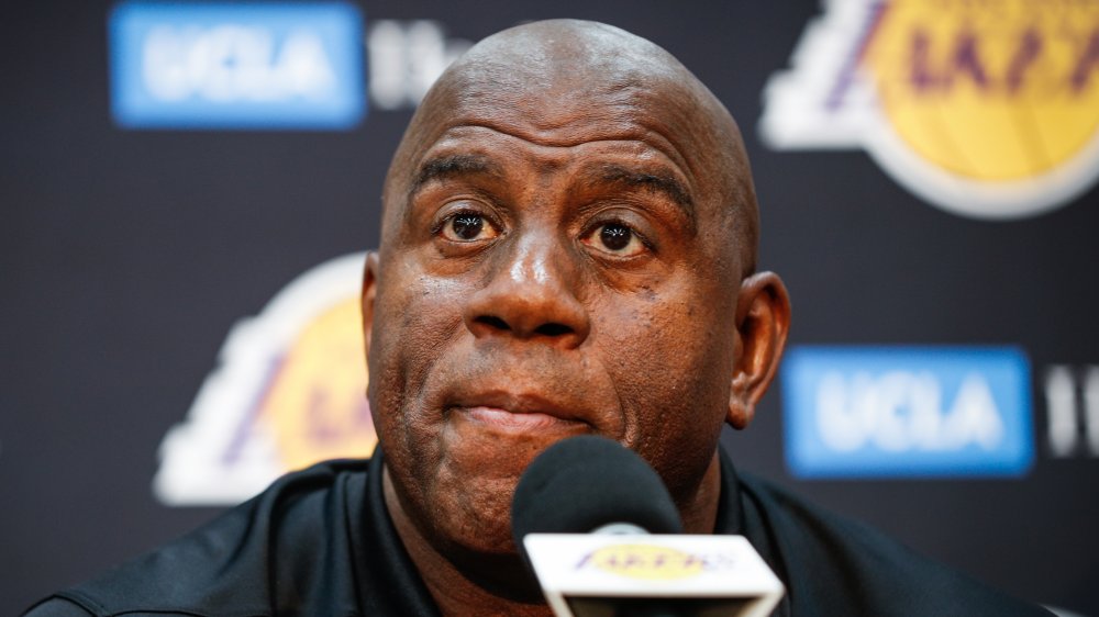 Earvin Magic Johnson at a microphone, sitting