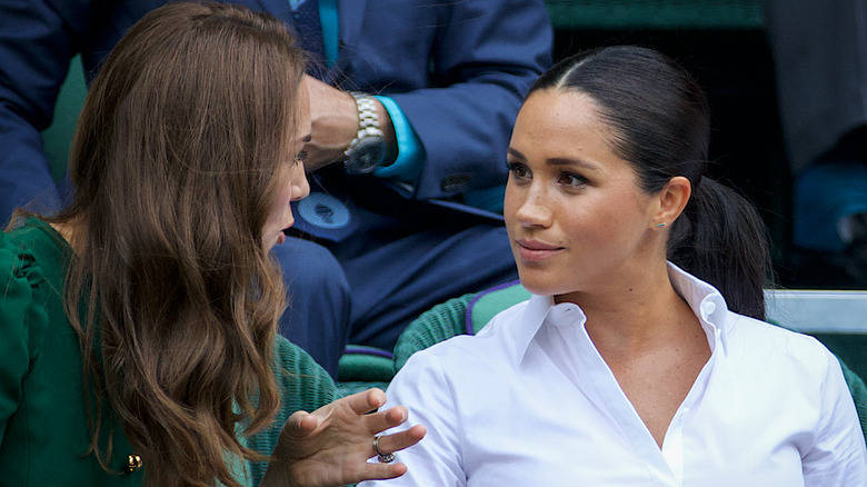 Kate Middleton and Meghan Markle talking