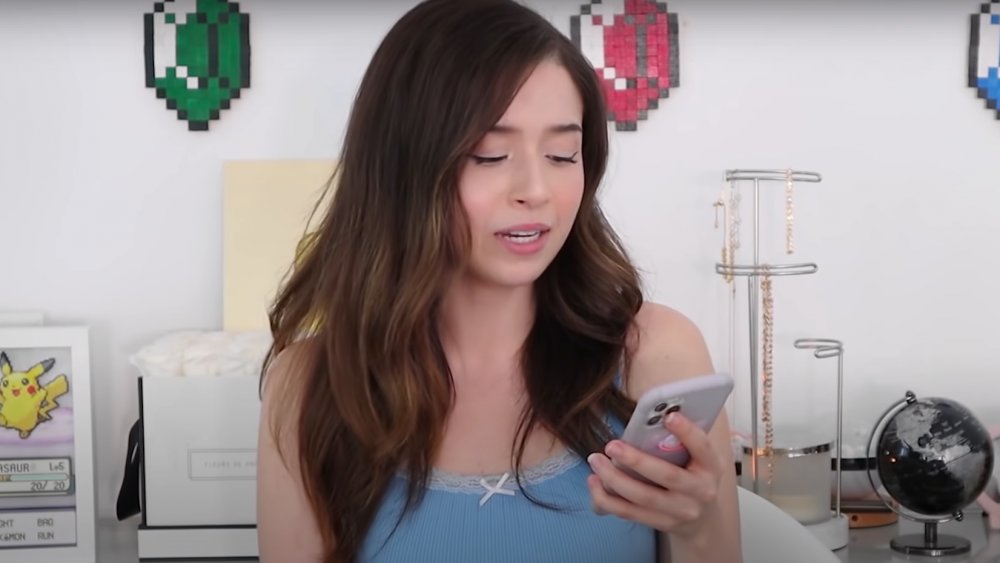 Pokimane looking at her phone 