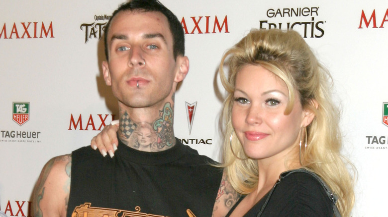 Shanna Moakler's arm around Travis Barker