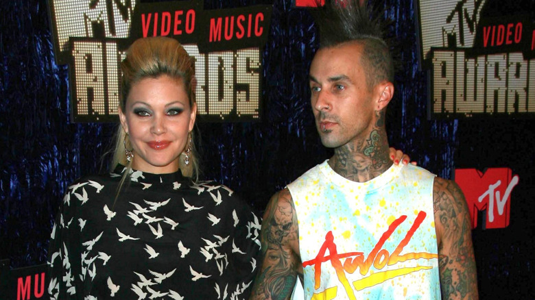 Shanna Moakler and Travis Barker hand in hand younger years