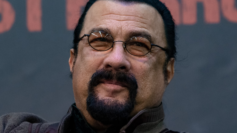 Steven Seagal smiling wearing glasses 