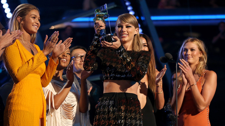 Taylor Swift accepts award as her squad cheers