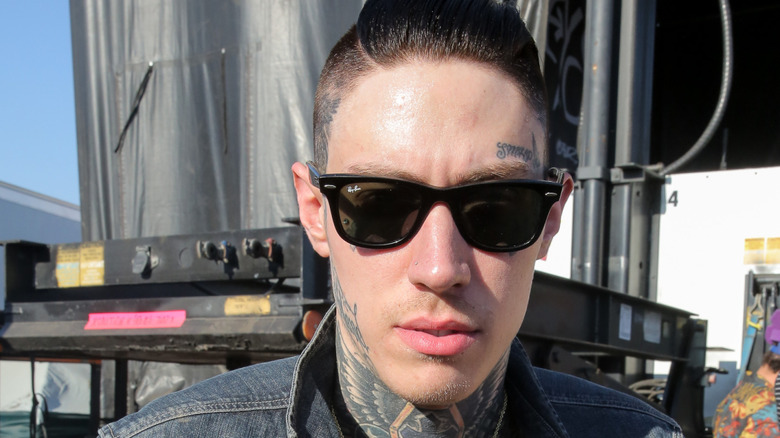 Trace Cyrus posing for cameras outdoors in shades