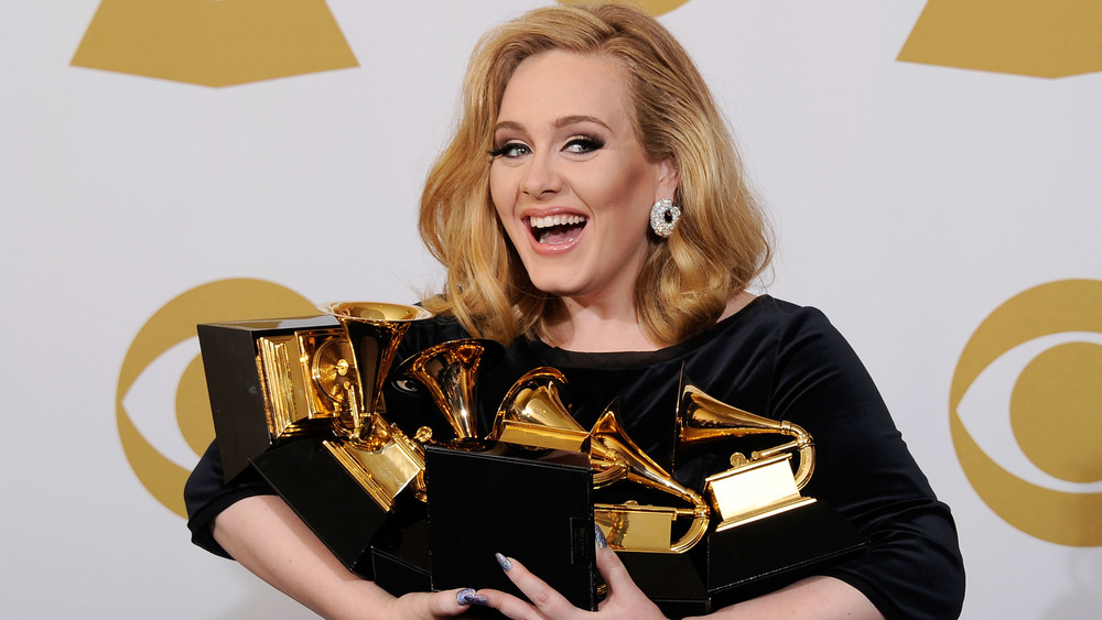 Adele holding all her Grammys