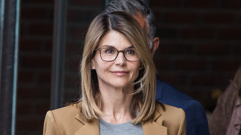 Lori Loughlin smiling while leaving court