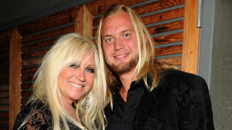 Linda Hogan leans toward Charlie Hill and poses with a smile