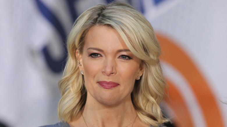 Megyn Kelly in 2017, posing in front of a NBC-generated banner