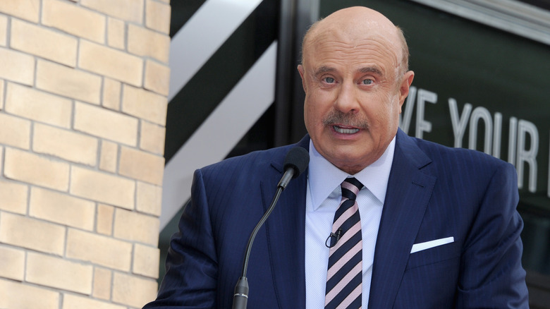 Dr. Phil behind a podium