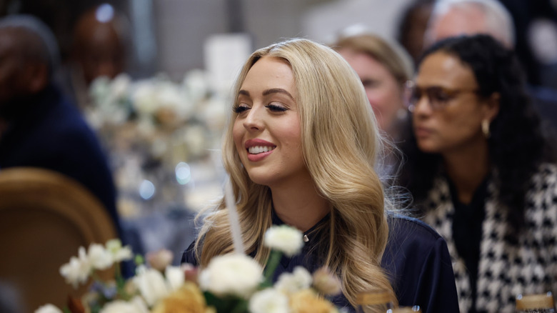 Tiffany Trump smiling at a table with flowers