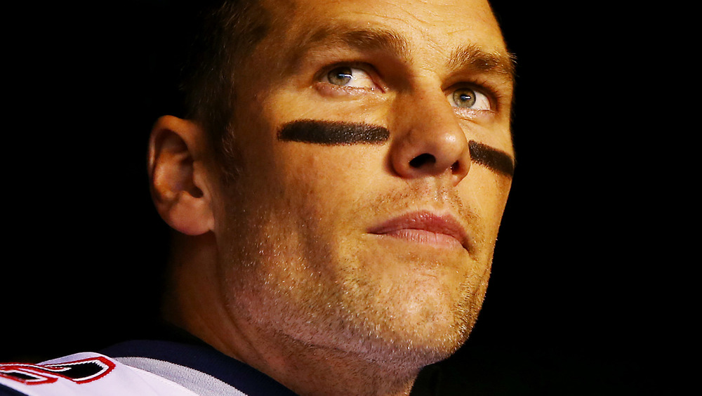 Tom Brady wearing grease paint, looking serious 