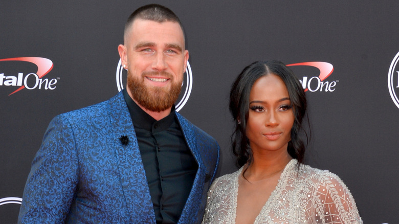 Travis Kelce and Kayla Nicole smiling and posing on the red carpet at the 2018 ESPYs