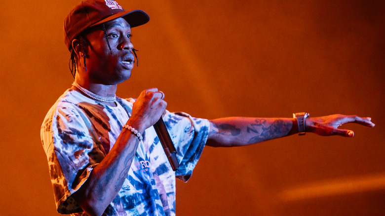 Travis Scott holding a microphone