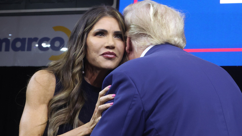 Kristi Noem hugging Donald Trump