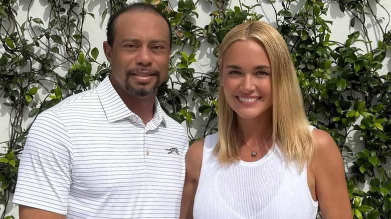 Tiger Woods posing with Vanessa Trump