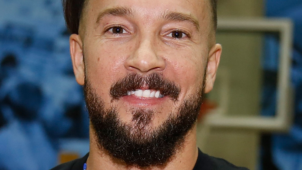 Carl Lentz sporting a full beard and smiling 