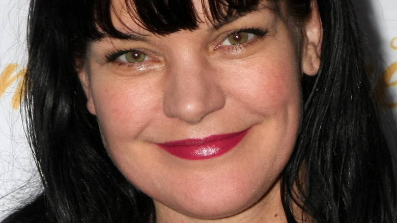 Pauley Perrette smiles in red lipstick