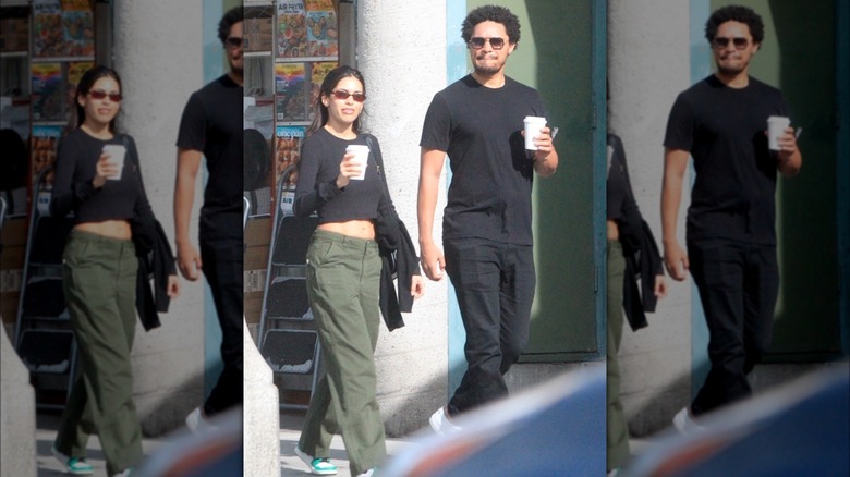 Trevor Noah with Juliana Herz walking with coffee