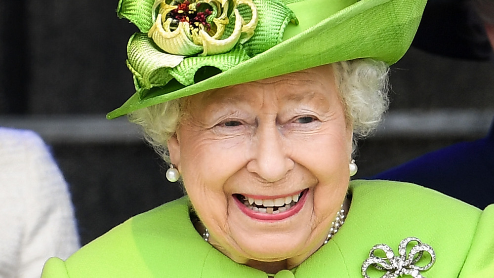 Queen Elizabeth laughing at an event