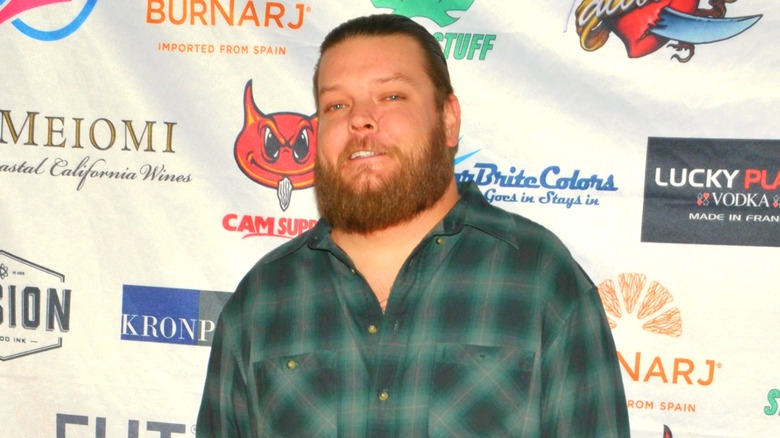 Corey Harrison wearing green plaid shirt