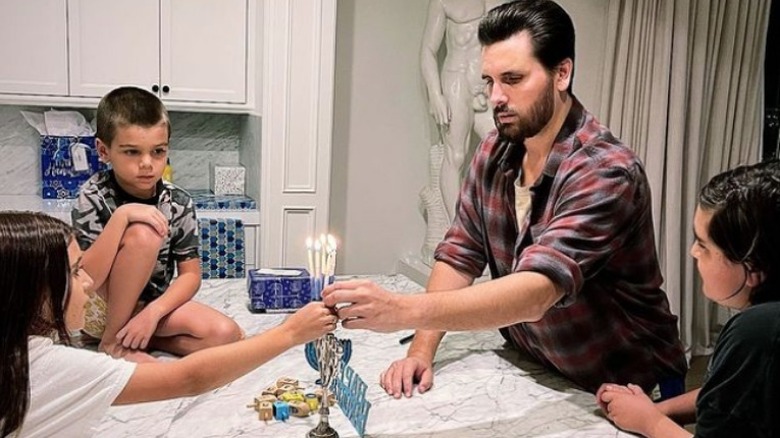 Scott Disick and his children lighting Hanukkah candles