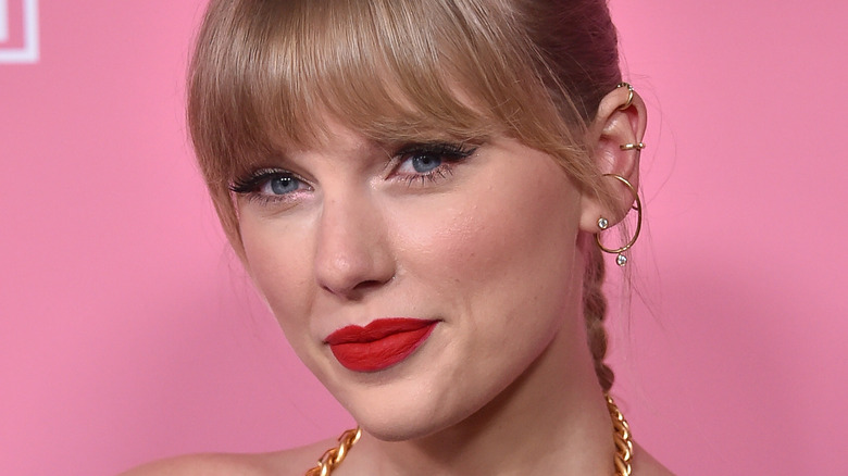 Smirking Taylor Swift with bangs