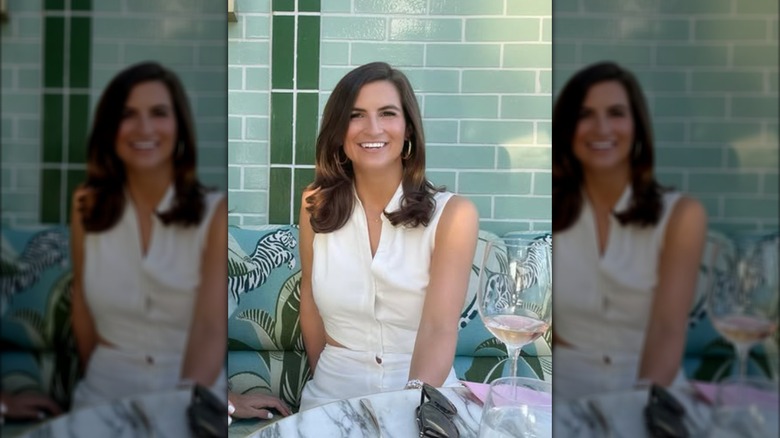 Kaitlan Collins posing for a photo seated at a restaurant.