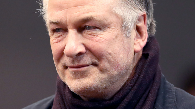 Alec Baldwin smiling while wearing scarf