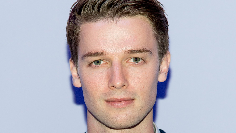 Patrick Schwarzenegger smiling slightly