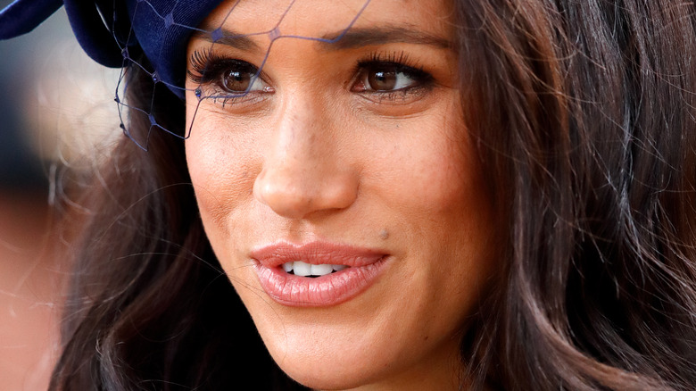 Meghan Markle with a neutral expression