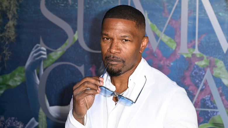 Jamie Foxx holding glasses