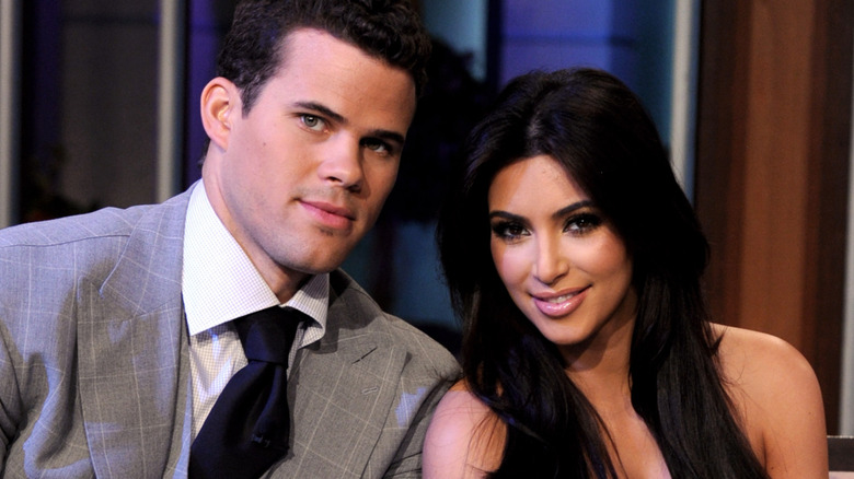 Kris Humphries and Kim Kardashian leaning in close to one another