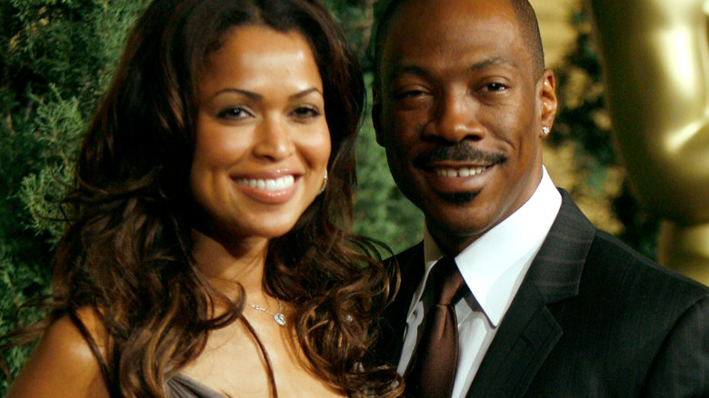Tracey Edmonds and Eddie Murphy smiling on a red carpet