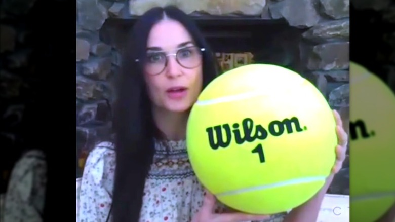 Demi Moore holding giant tennis ball