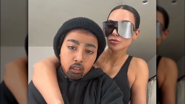 North West in Kanye West makeup with Kim Kardashian