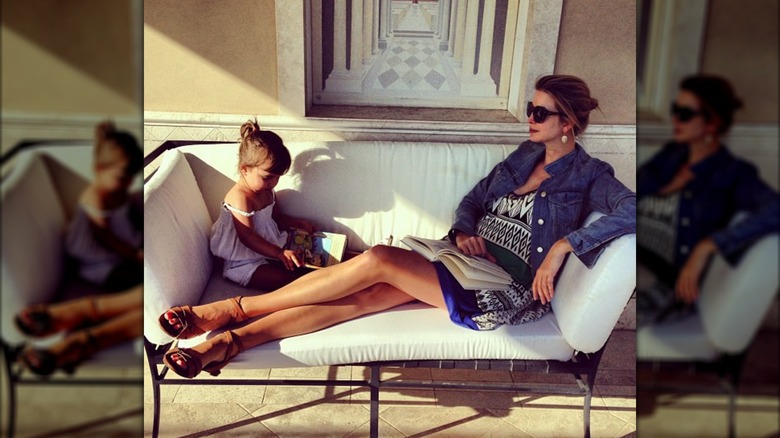 Ivanka Trump with legs stretched out on couch beside Arabella Kushner