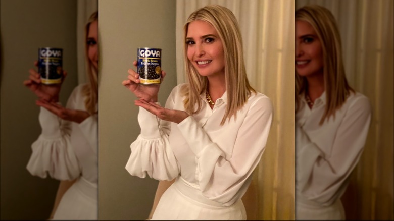 Ivanka Trump wearing a white outfit and holding a can of beans