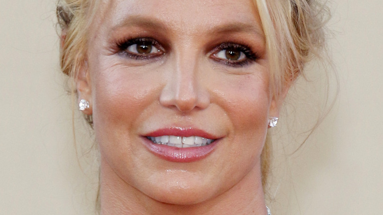 Britney Spears smiles on a red carpet
