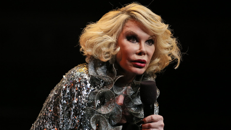 Joan Rivers performing onstage with microphone