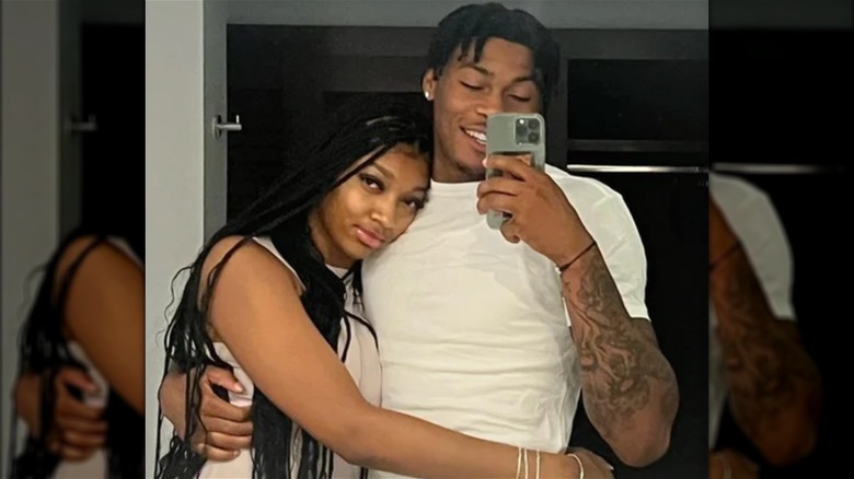 Angel Reese and Cam'Ron Fletcher posing in a mirror selfie