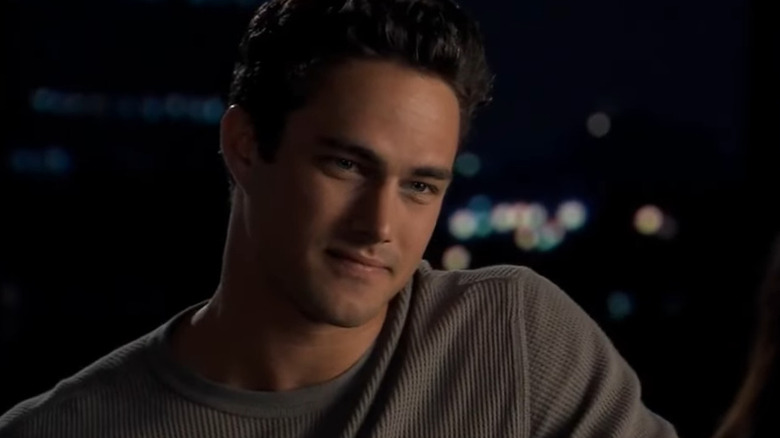 Taylor Kinney as Luke Gianni, looking on